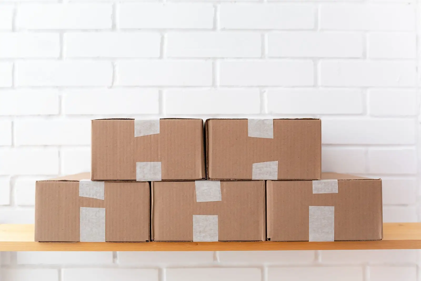 Neatly stacked shipping boxes on a shelf