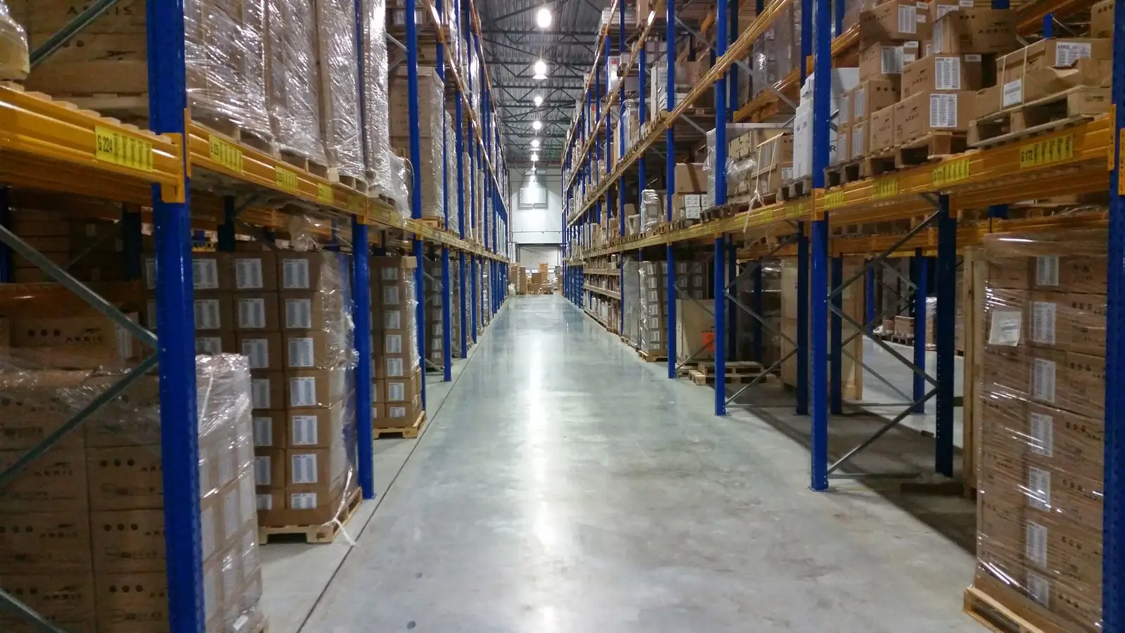Long warehouse aisle with stocked racking on both sides
